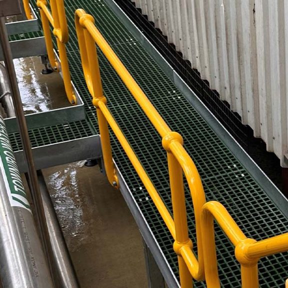 metal fabricated yellow walkway for milk facility